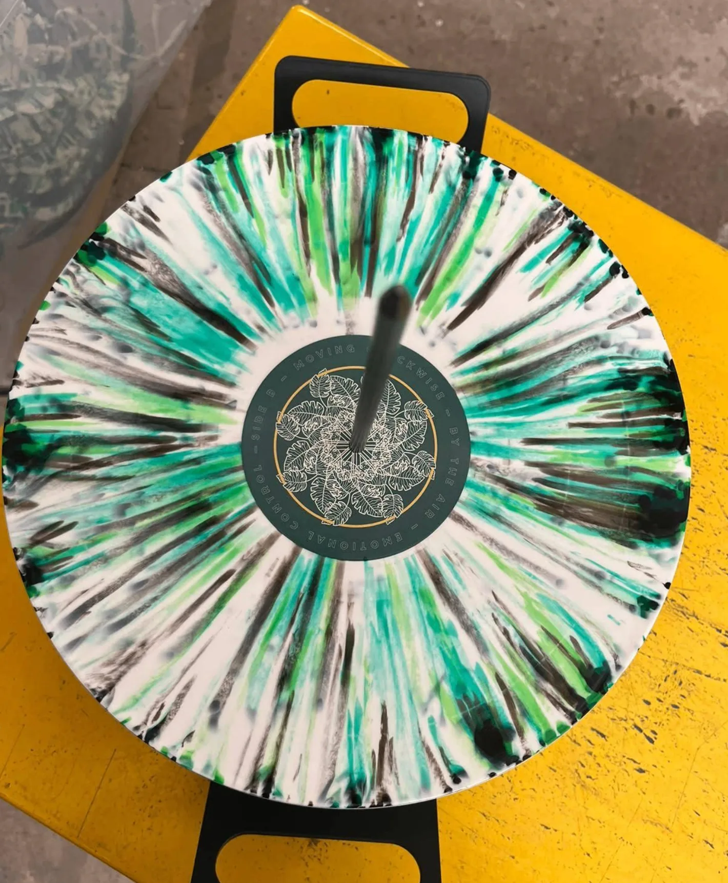 Green and black splatter vinyl on yellow turntable — Unified Artist Services pressing